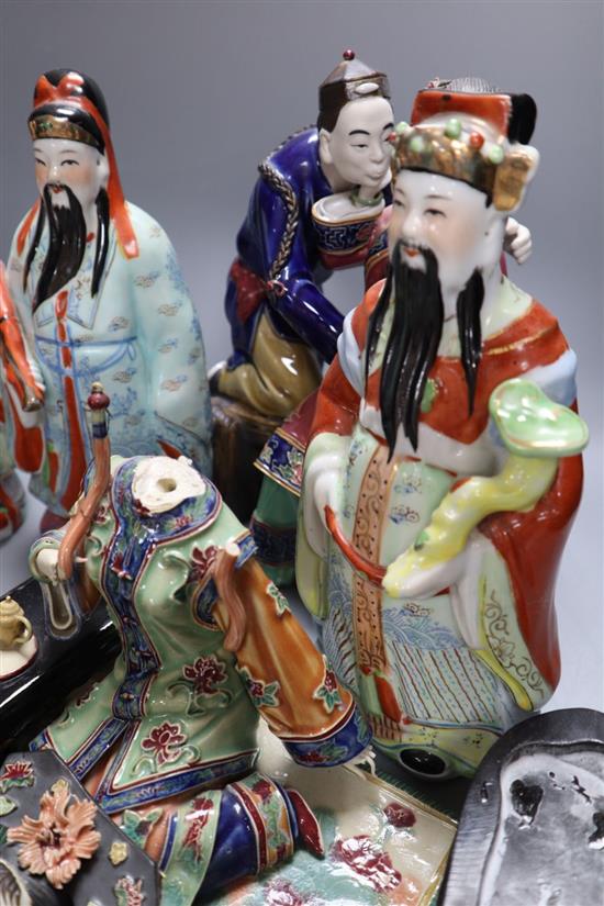 Three Chinese enamelled porcelain figures of immortals, tallest 24cm, three Shiwan type pottery groups, an agate necklace and a carving